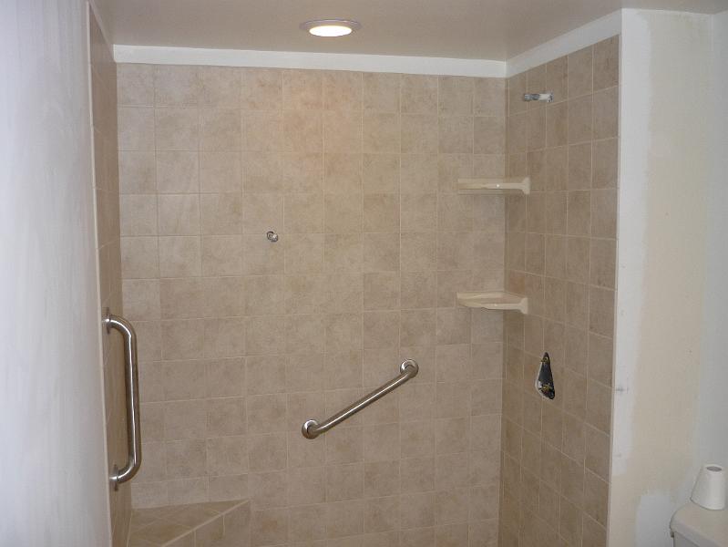 P1010122.JPG - Shower is tiled. The hand rail supports are mounted.