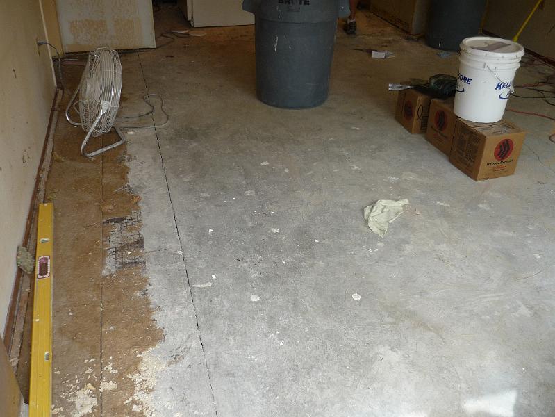 P1010079.JPG - Old flooring is removed all the way down to the cement slab.